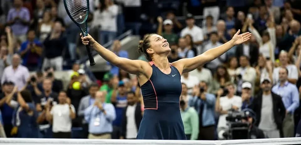 Tennis player celebrating victory with arms raised