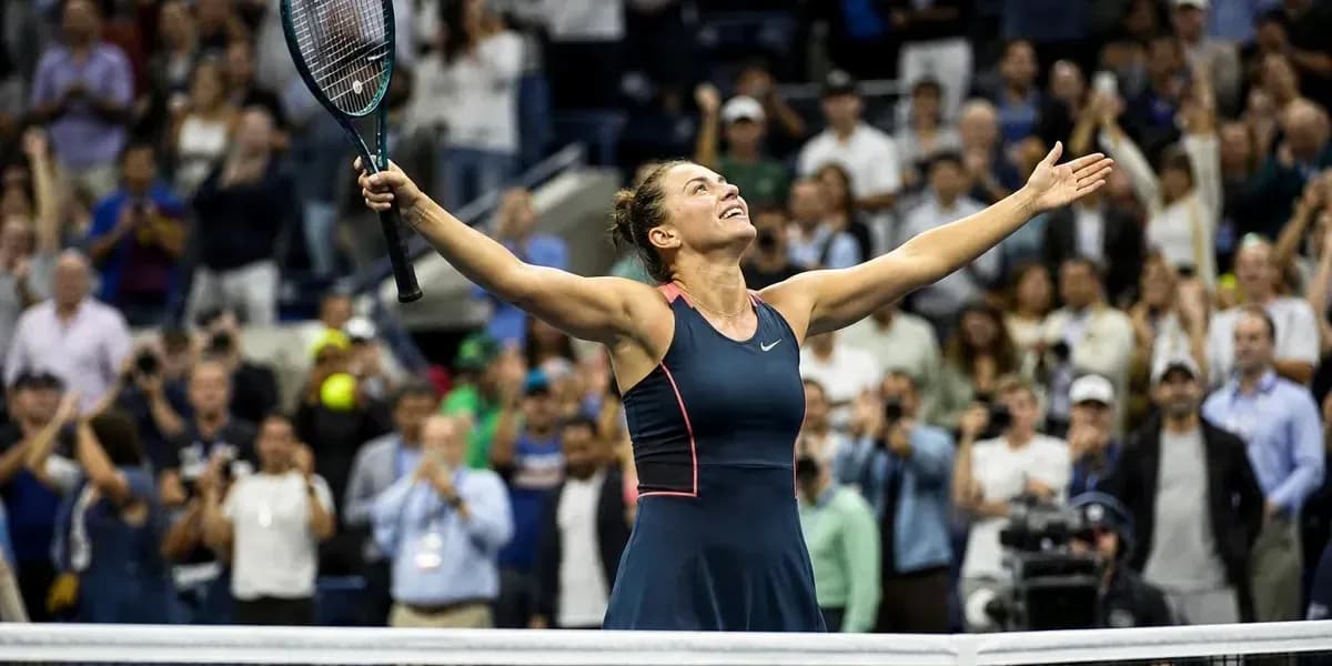 Tennis player celebrating victory with arms raised