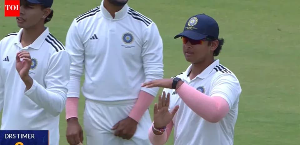 Cricket players discussing strategy on the field