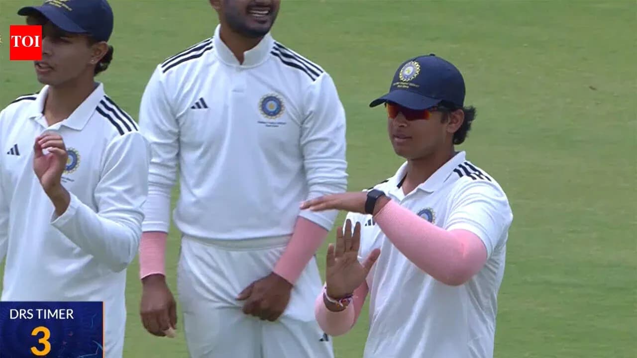 Cricket players discussing strategy on the field