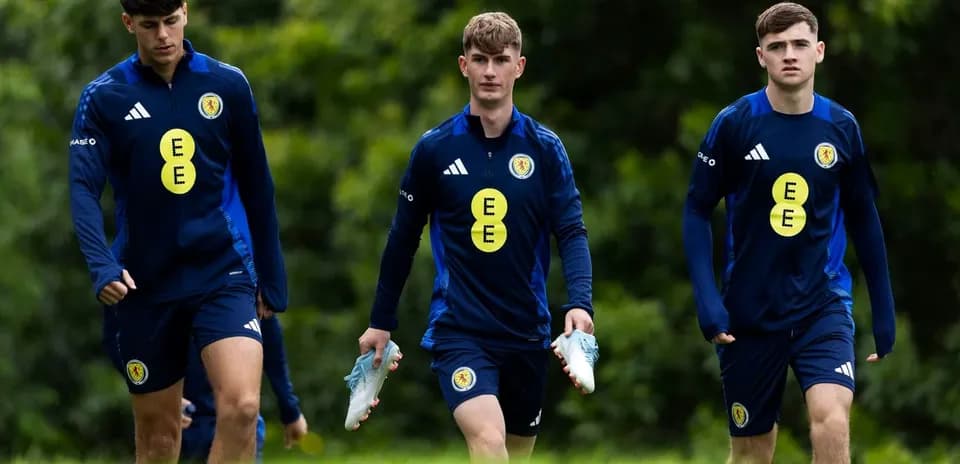 Three Scotland players walking during training session