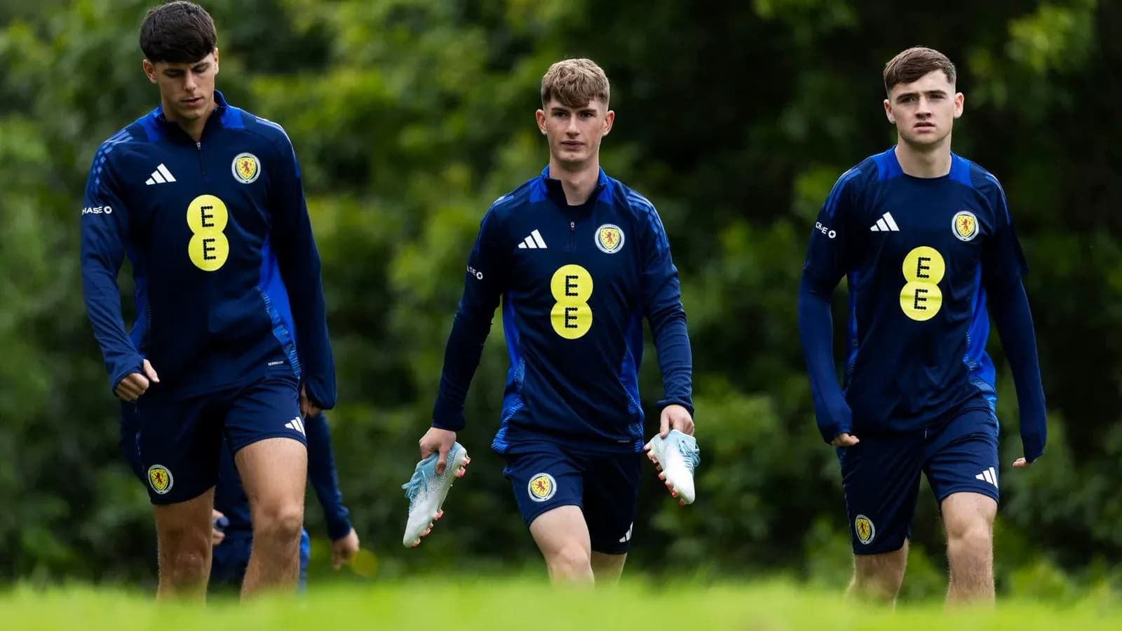 Three Scotland players walking during training session