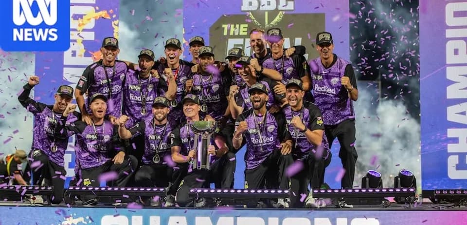 Team celebrating victory with trophy and confetti