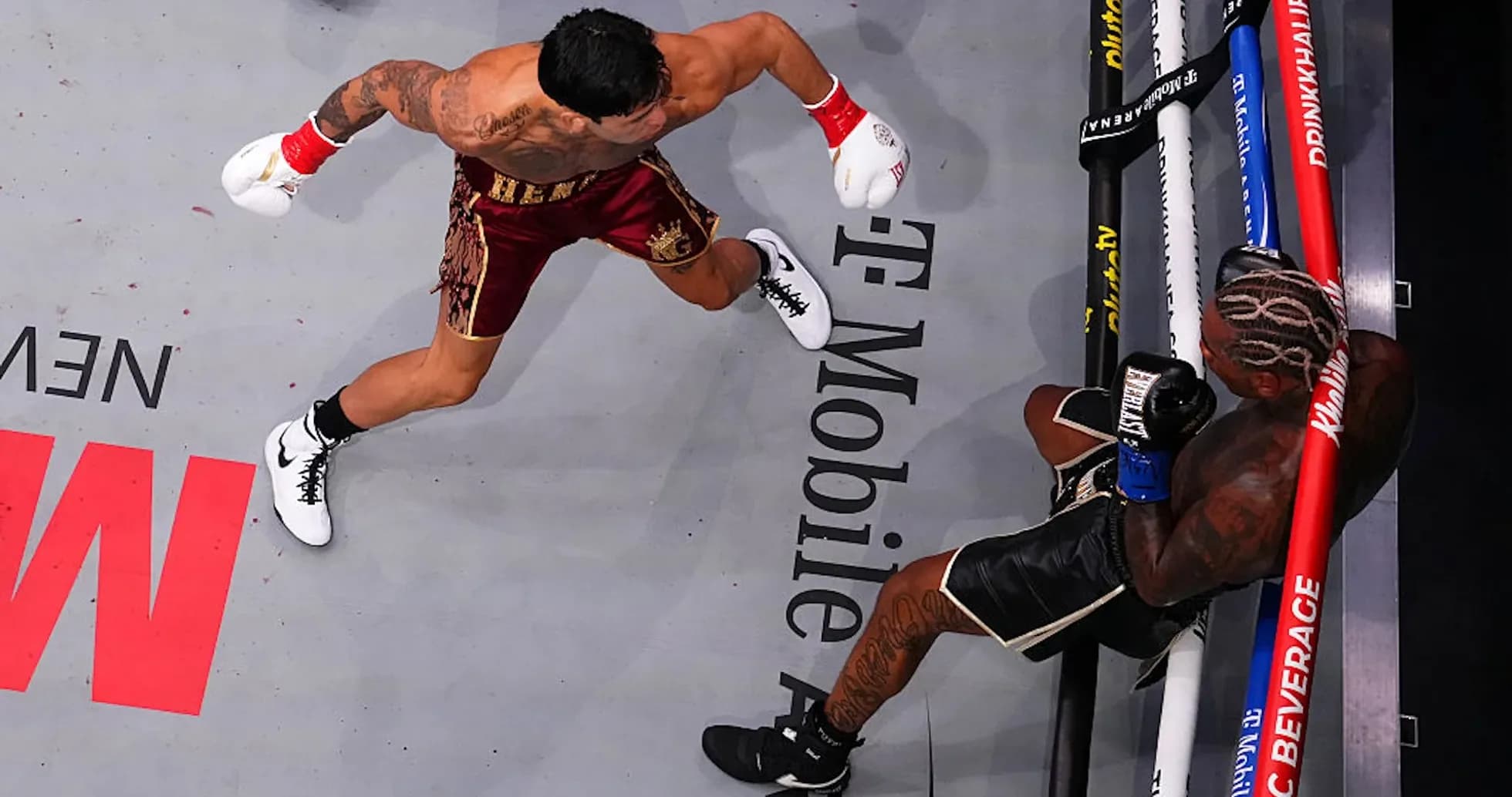 Boxer delivering a punch to opponent in ring