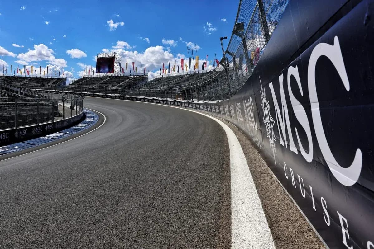 Curved racetrack with grandstands and advertising banners