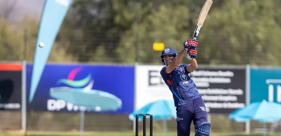 Batsman striking ball during cricket match