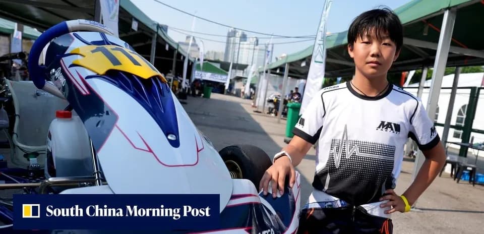 Young driver standing next to kart in paddock