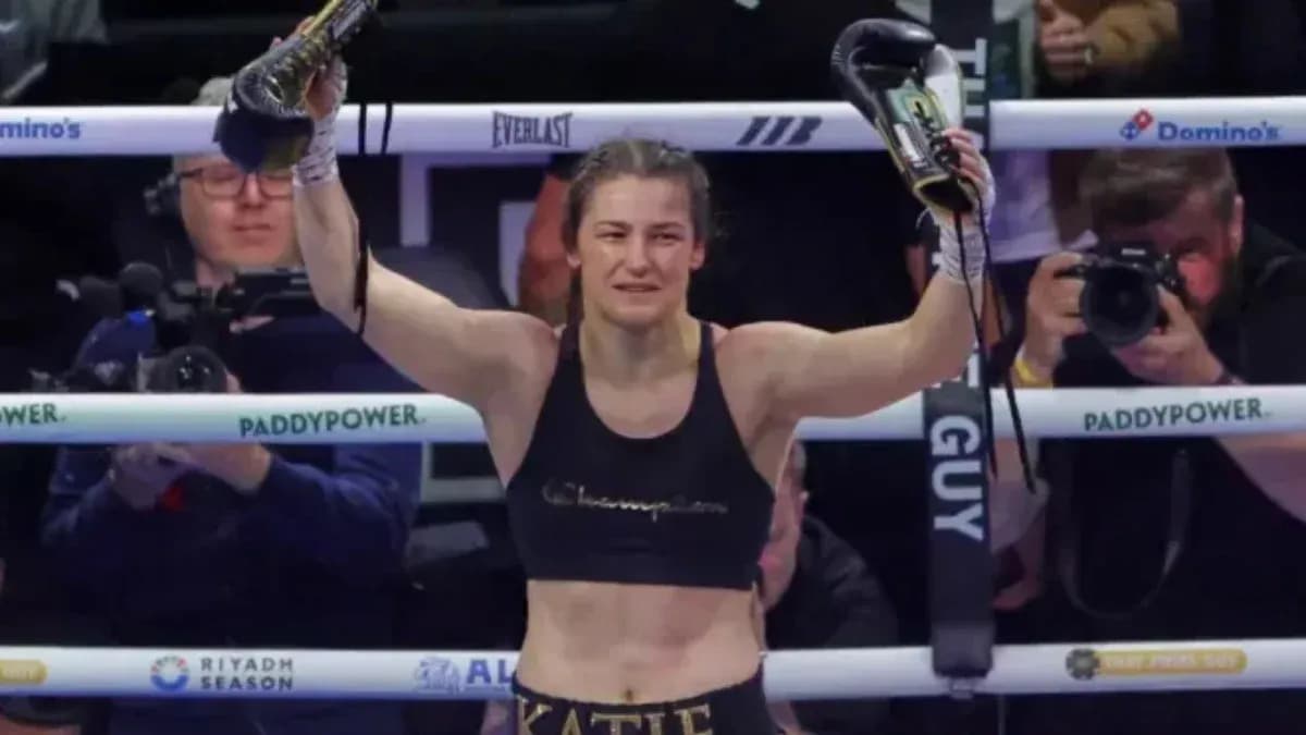 Female boxer celebrating victory in the ring