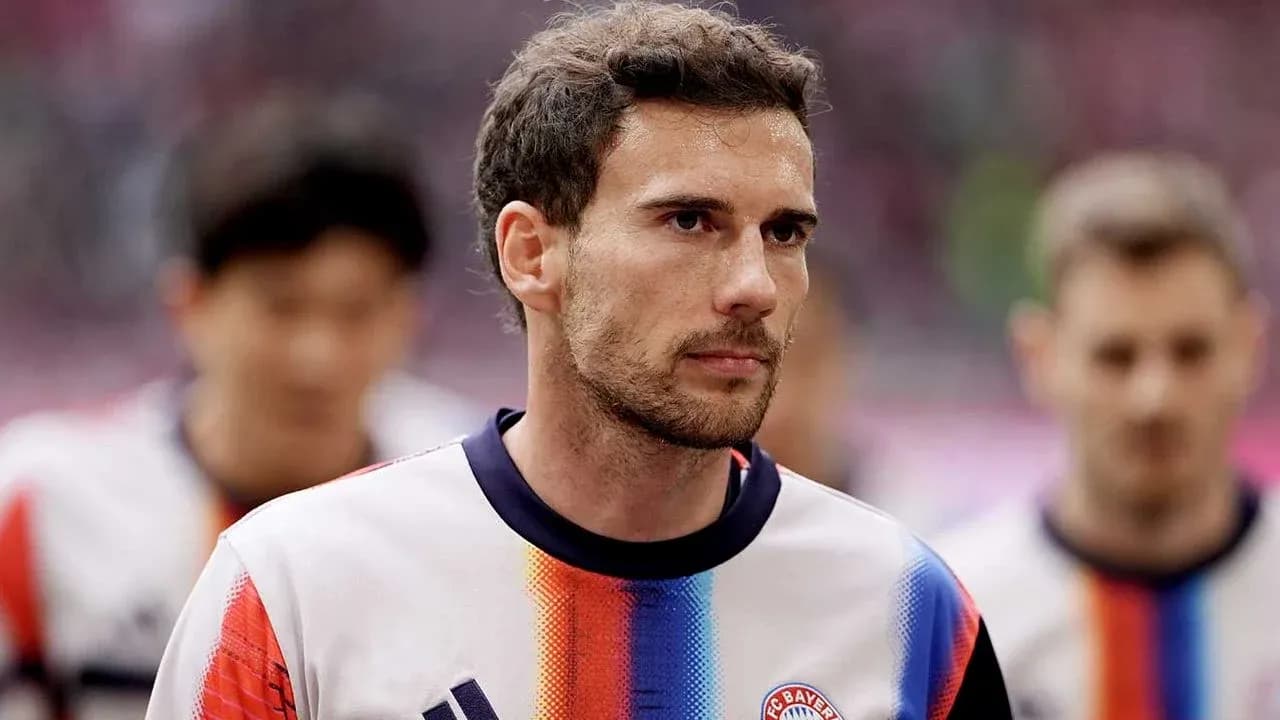 Player walking onto the pitch in team jersey