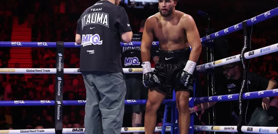Boxer receiving advice from trainer in corner