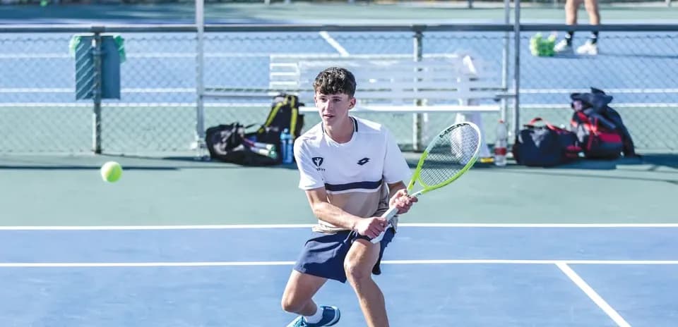 Young player hitting a tennis ball during practice