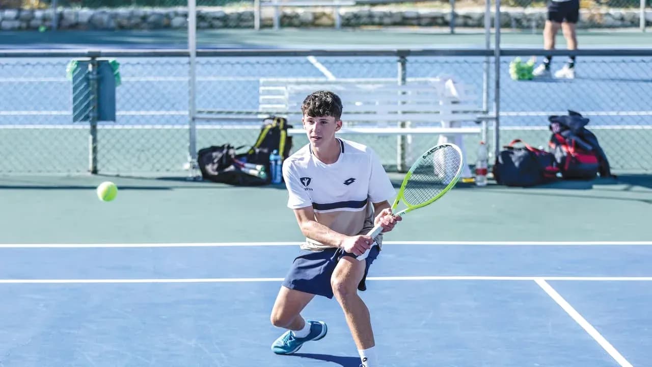 Young player hitting a tennis ball during practice