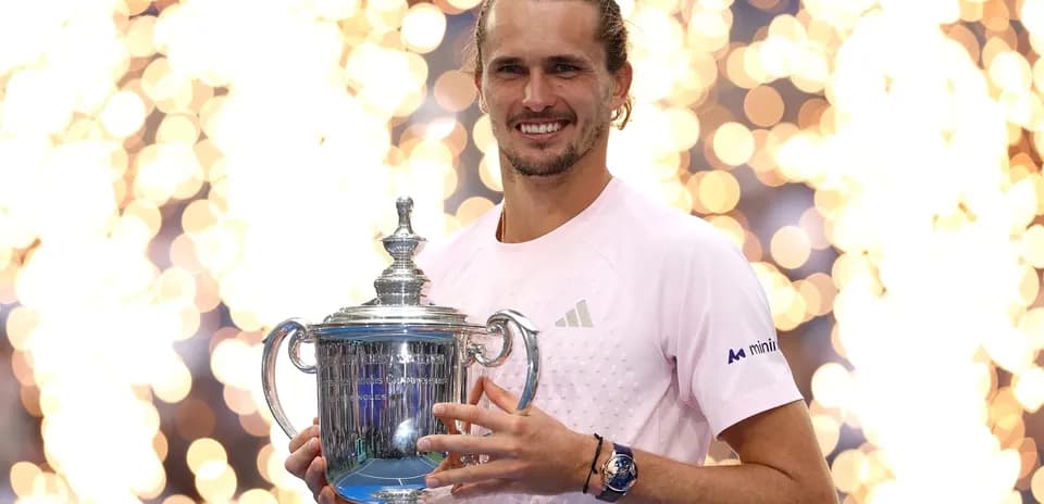 Player holding trophy with celebratory lights in background