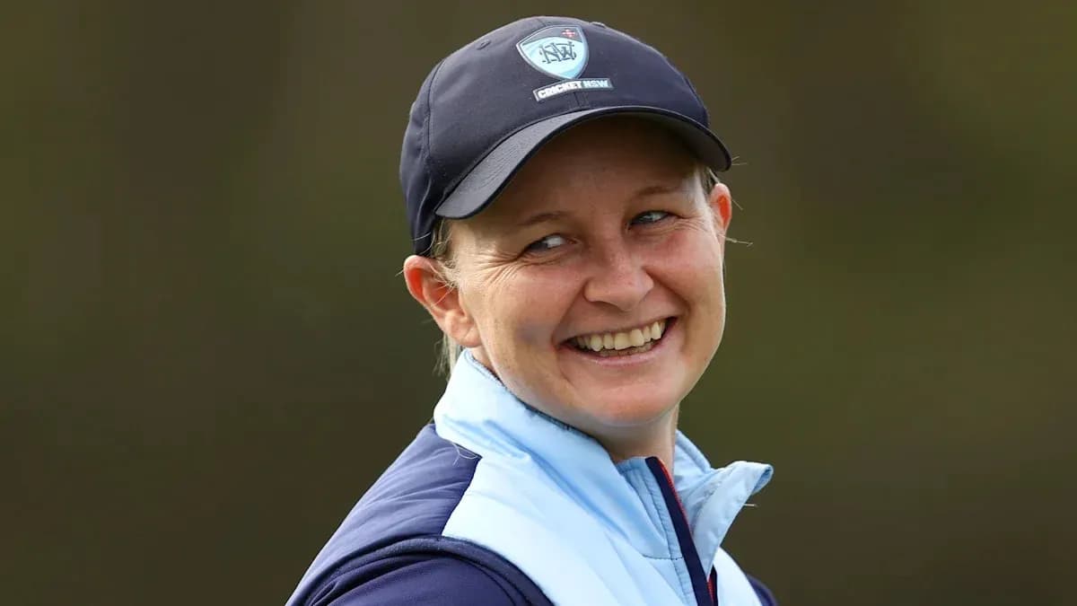 Cricket coach smiling during outdoor session