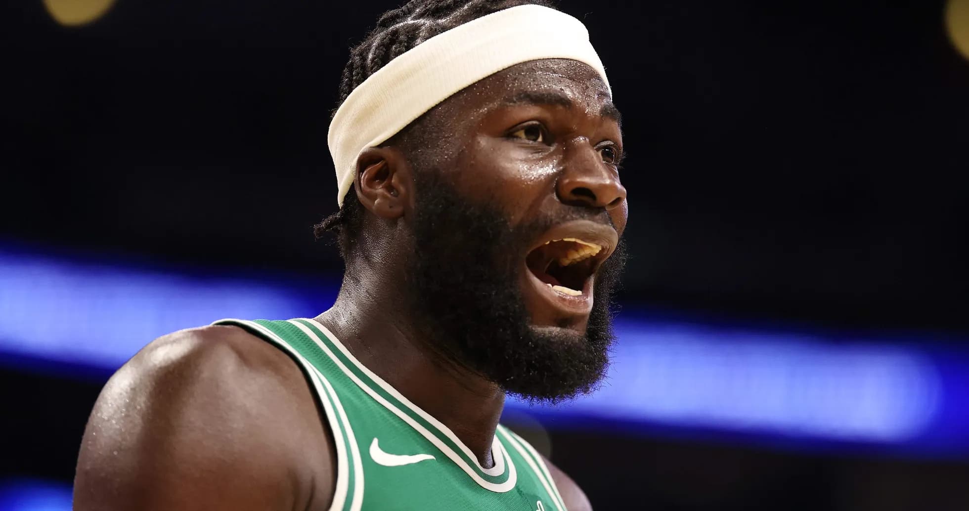 Player in green jersey celebrating during game