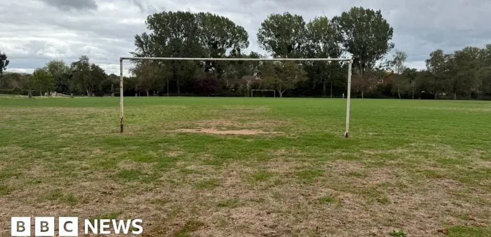 Empty football goal on grassy field
