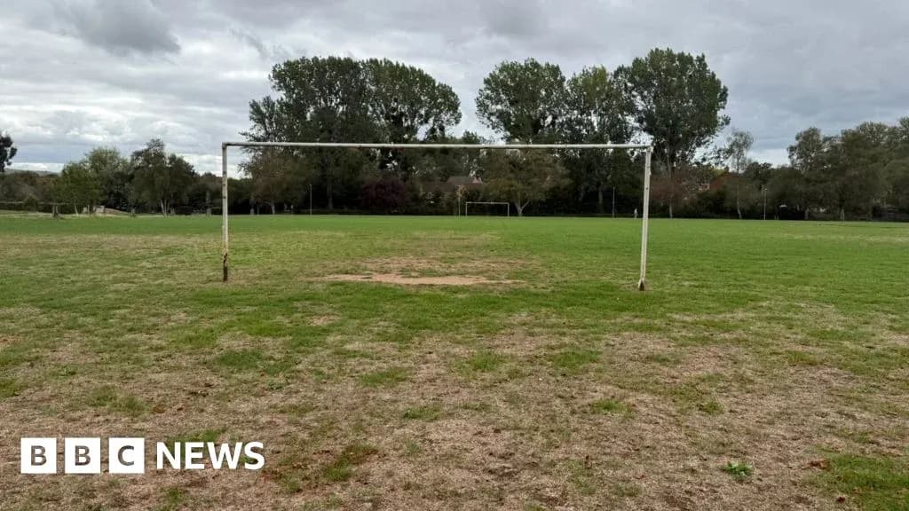 Empty football goal on grassy field