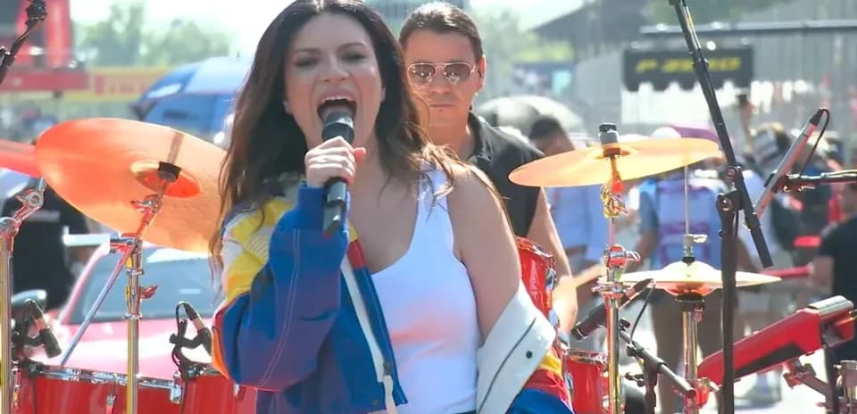 Singer performing with band at outdoor concert