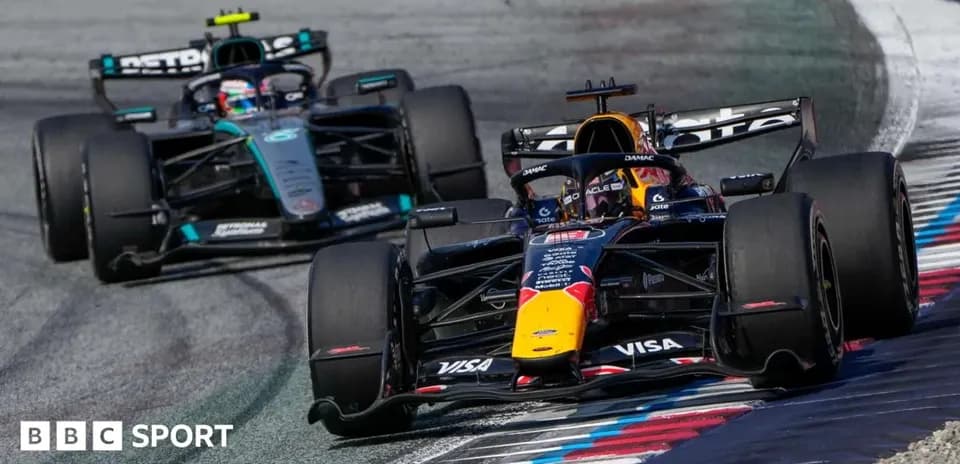 Two Formula 1 cars racing on track during event