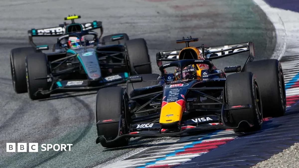 Two Formula 1 cars racing on track during event