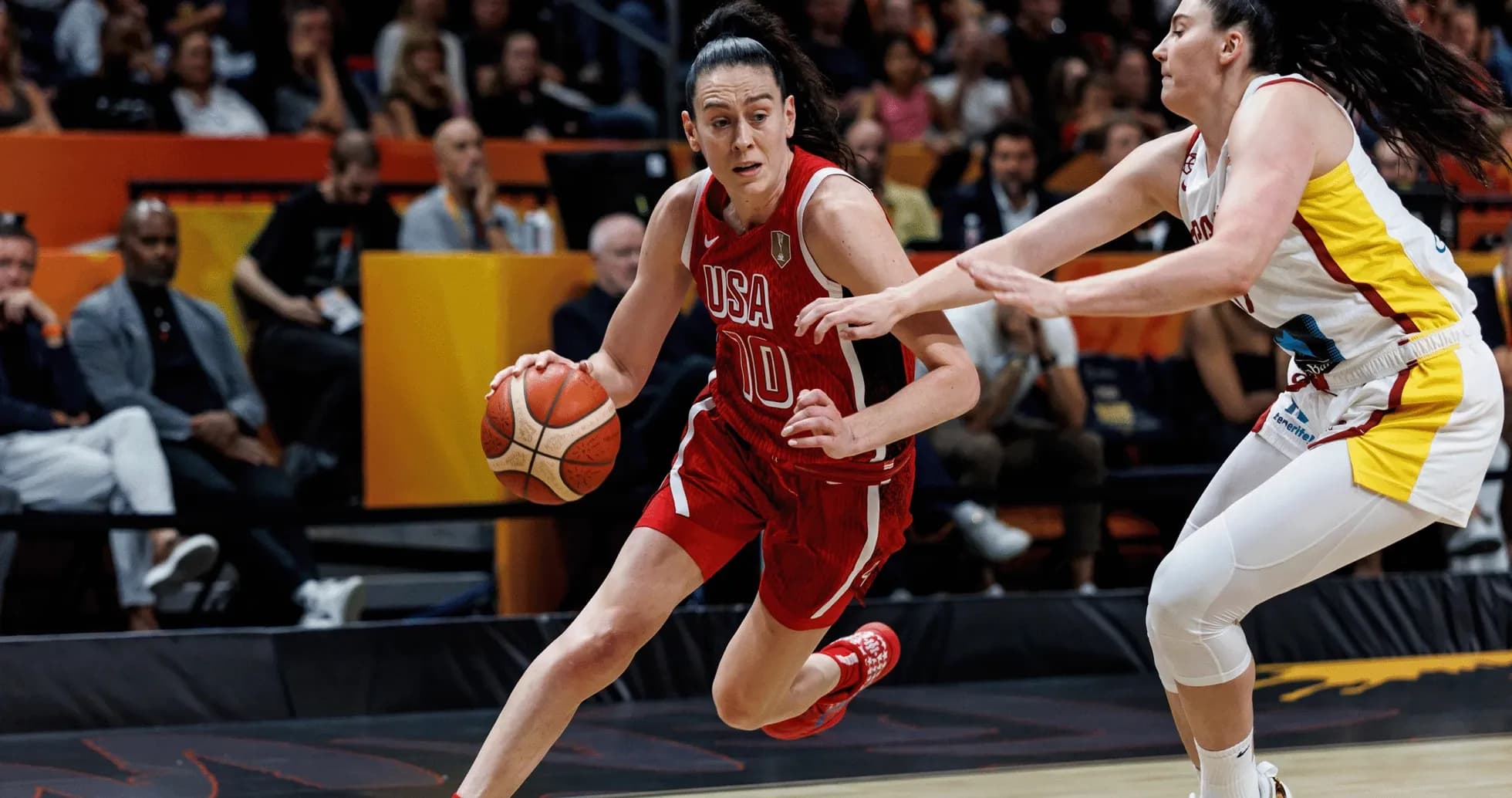 USA player dribbling past defender during basketball game