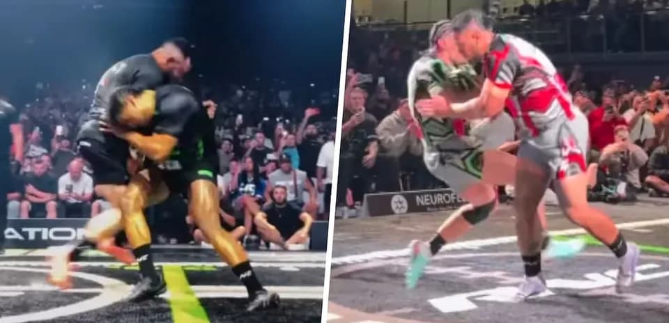Two wrestlers grappling in front of a cheering crowd