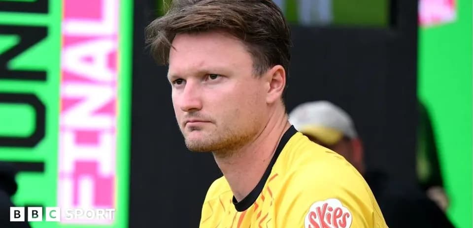 Player in yellow jersey sitting on bench during match