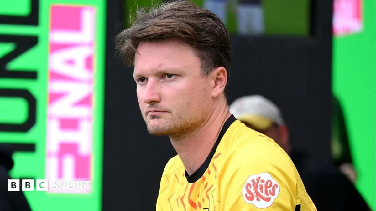 Player in yellow jersey sitting on bench during match