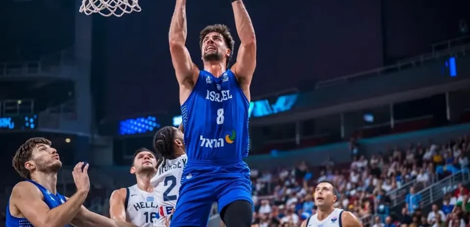 Player jumping to score during basketball match