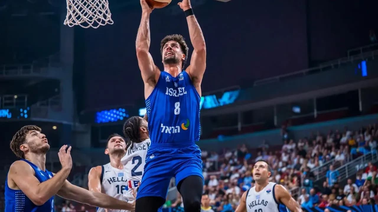 Player jumping to score during basketball match