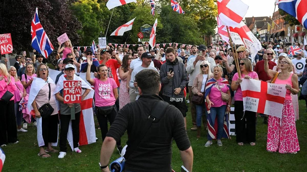 Large crowd protesting with signs and flags