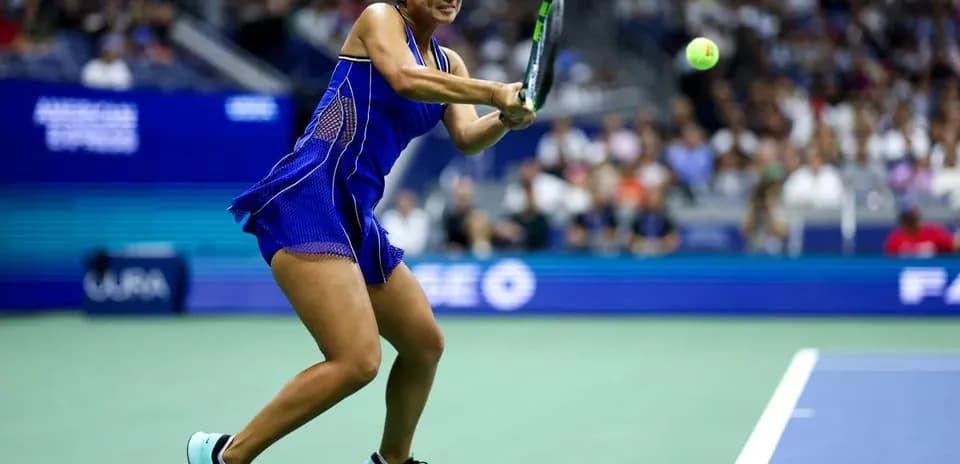 Player hitting a tennis ball during a match