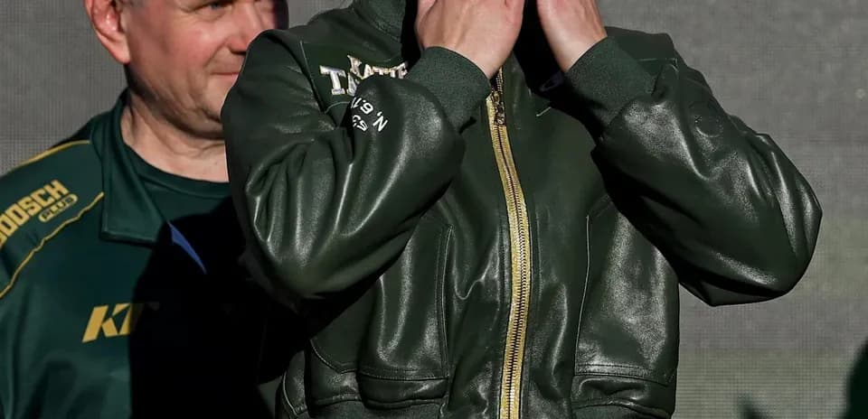Female boxer blowing kisses at weigh-in event