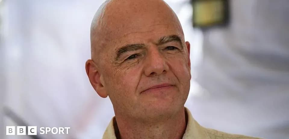 Man with a bald head speaking at an event