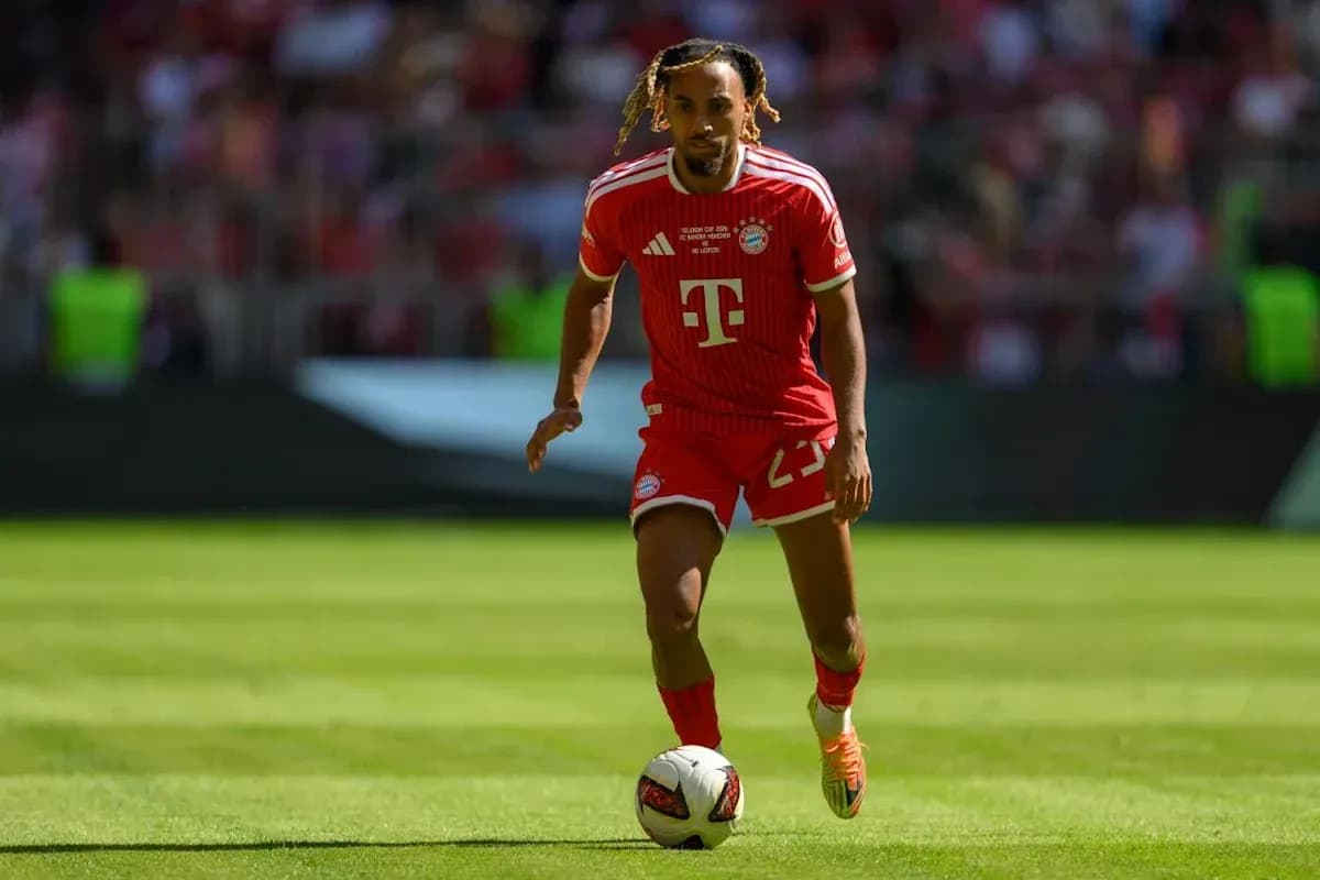 Player in red Bayern Munich kit running with ball