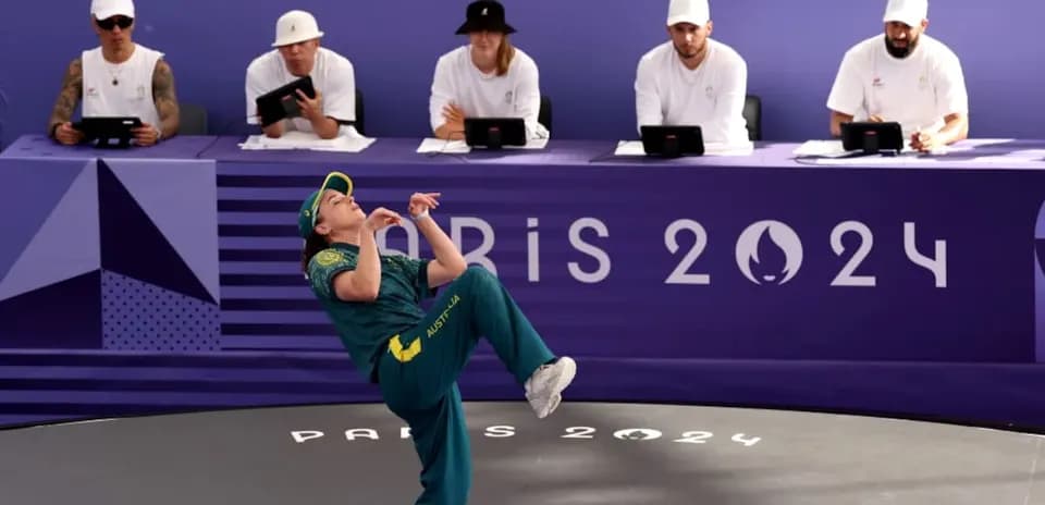 Athlete performing in front of judges at Paris 2024
