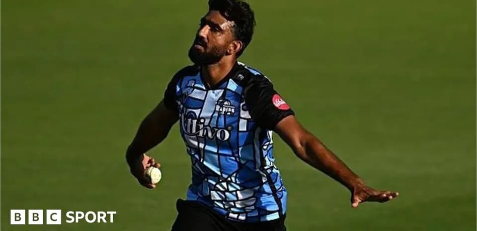 Cricketer bowling during a match on the field