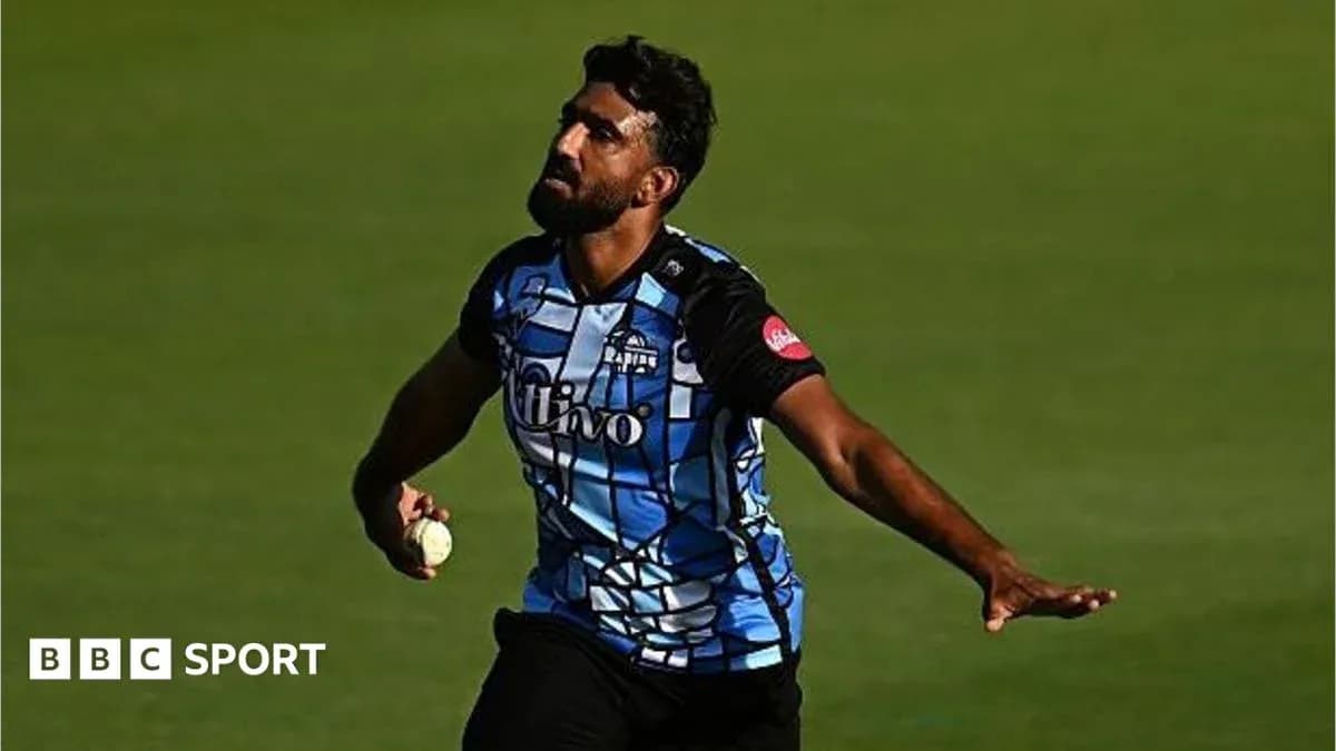 Cricketer bowling during a match on the field