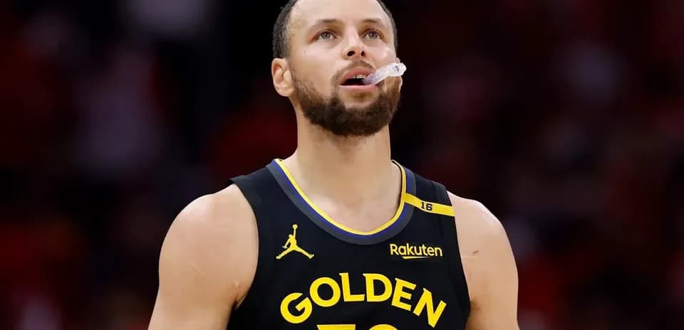Player wearing Golden State Warriors jersey on court