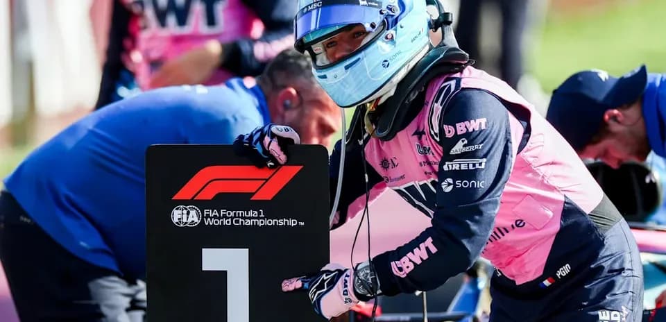 Driver holding number one sign during F1 event