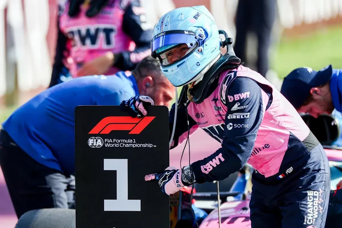 Driver holding number one sign during F1 event