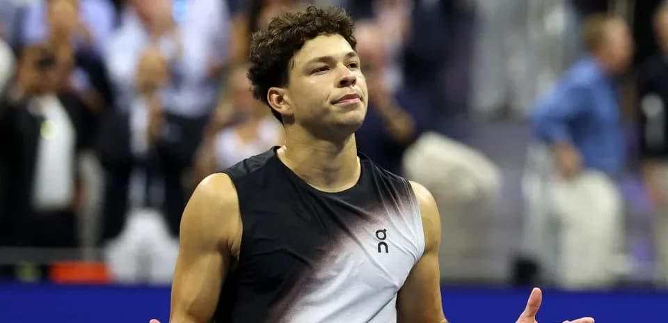 Tennis player gesturing during a match celebration