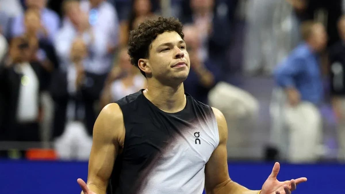 Tennis player gesturing during a match celebration