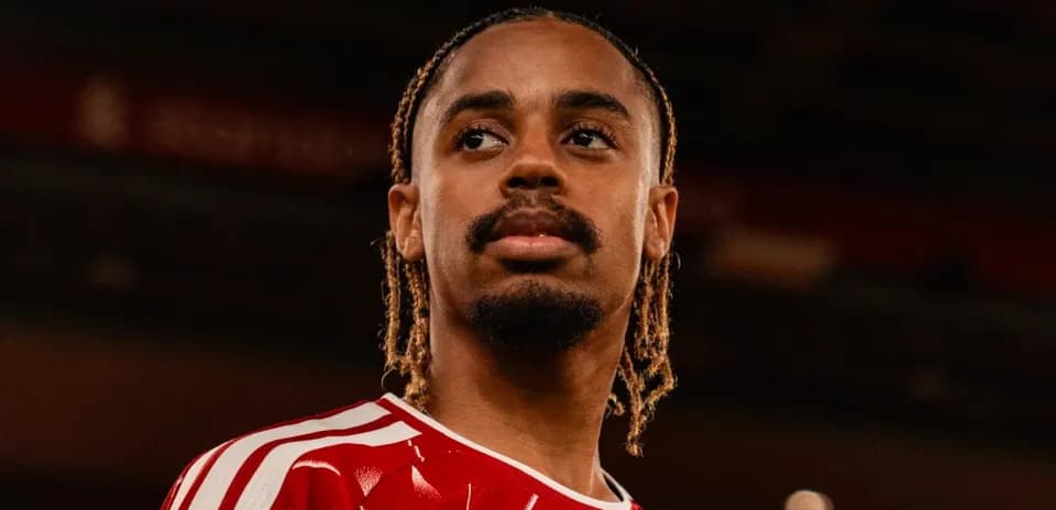 Player in red jersey looking thoughtfully