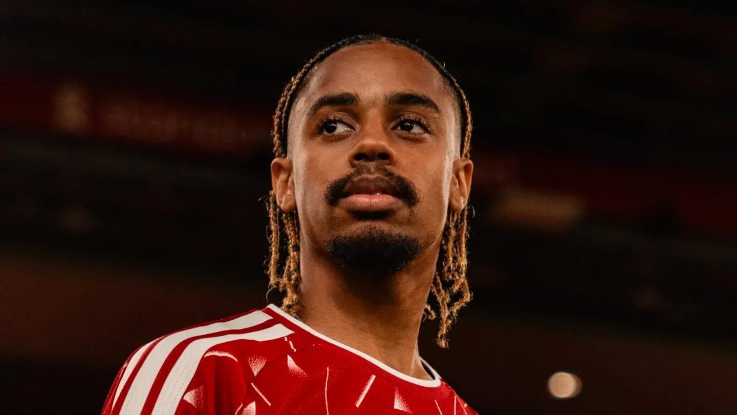 Player in red jersey looking thoughtfully