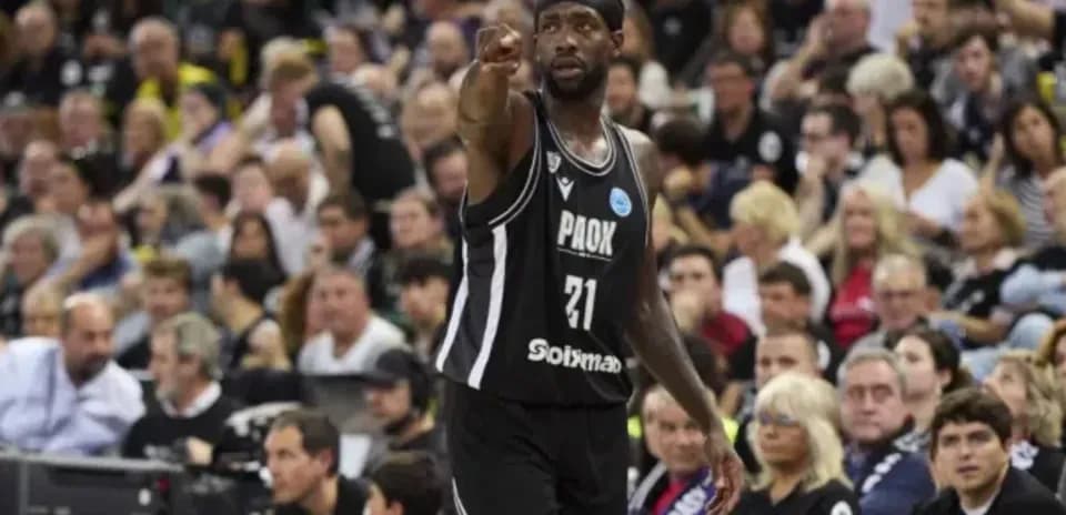 Player in black jersey pointing during basketball game