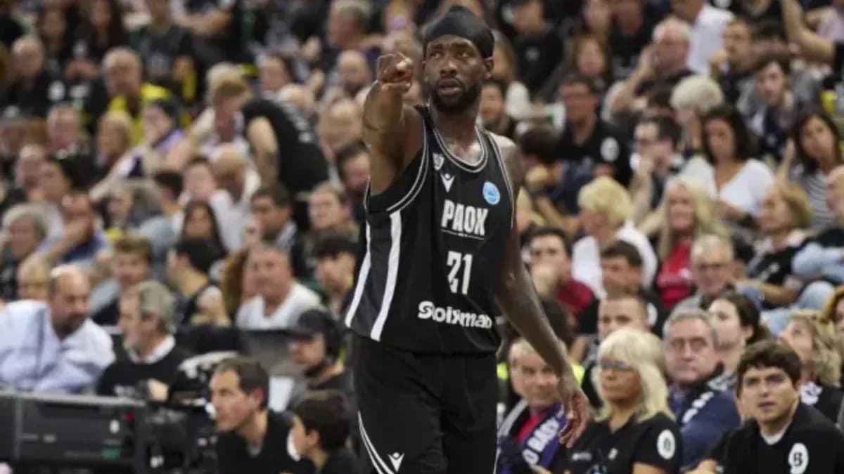 Player in black jersey pointing during basketball game