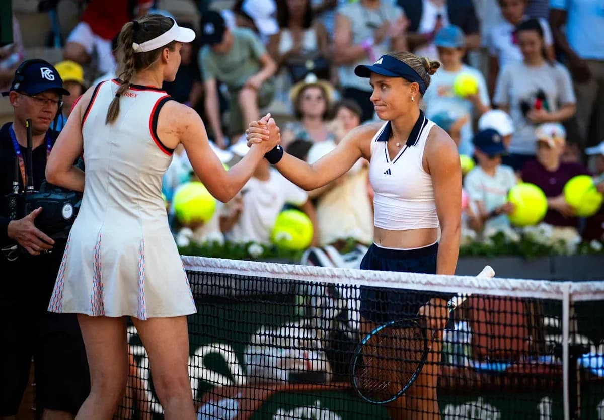 Two tennis players shaking hands at the net