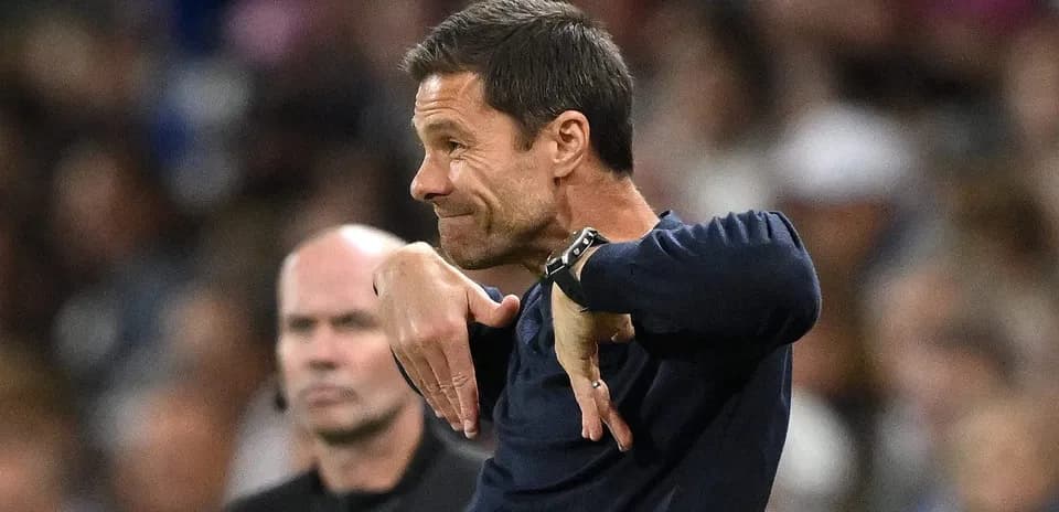Coach gesturing during match with referee in background