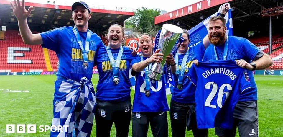 Celebrating team with trophy and champion shirts